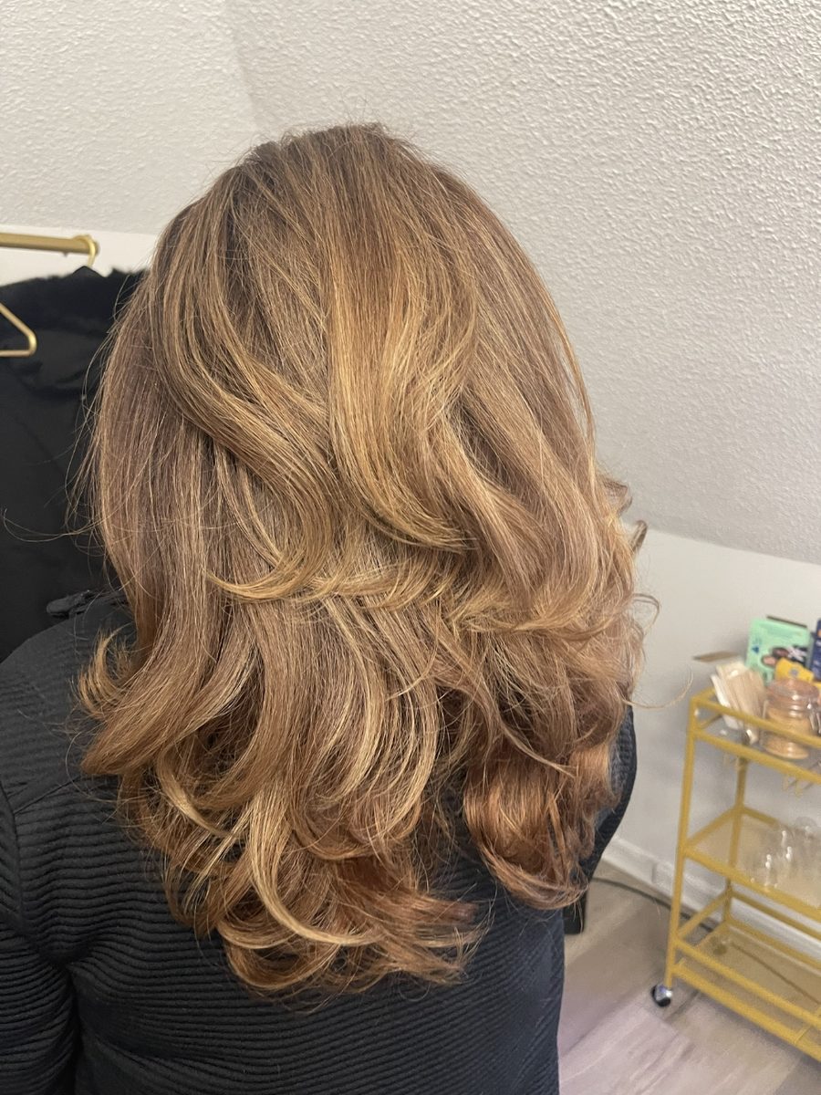 Bronde balayage styled in soft bouncy curls, back view