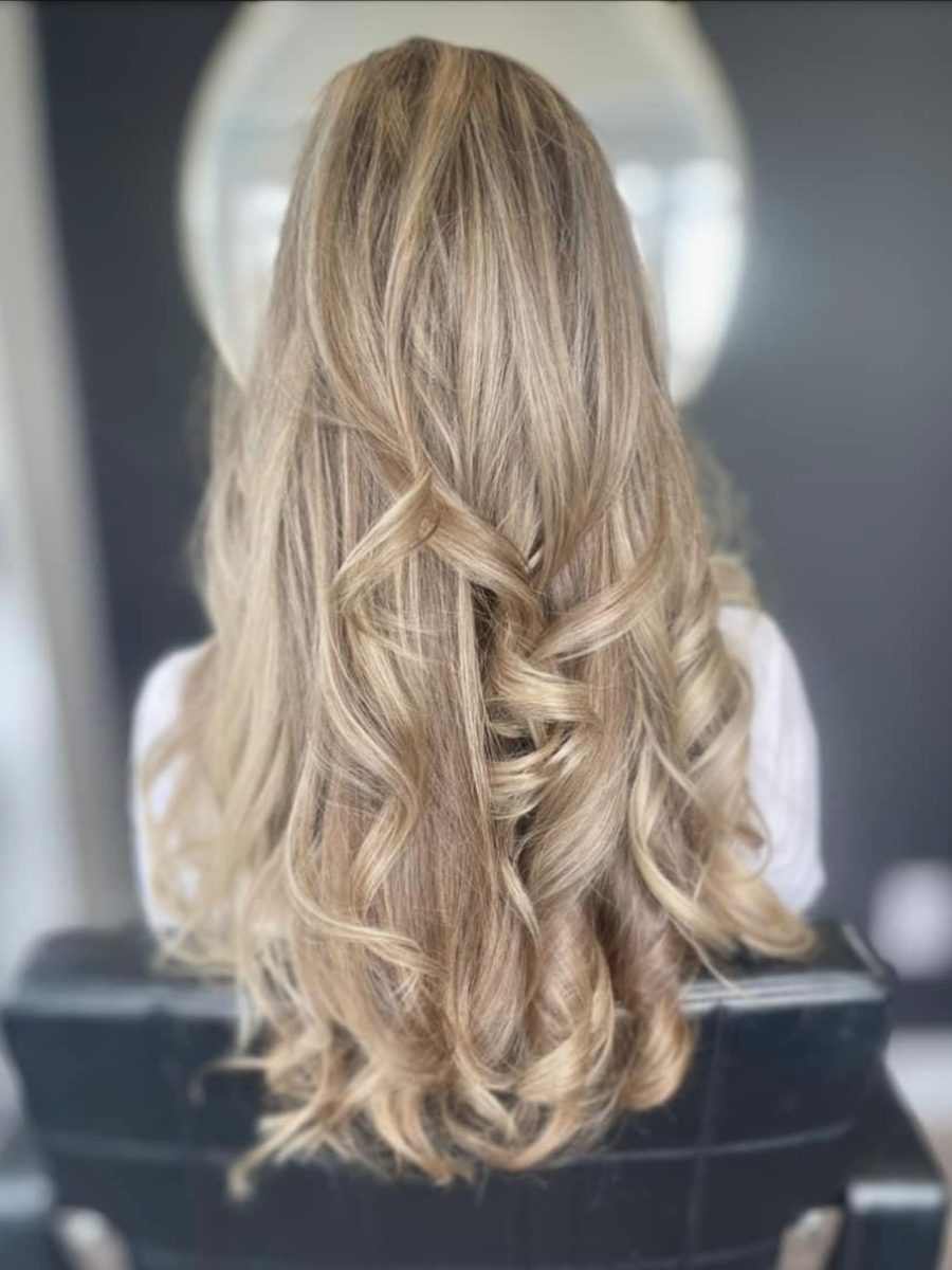 Blonde balayage styled in loose curls