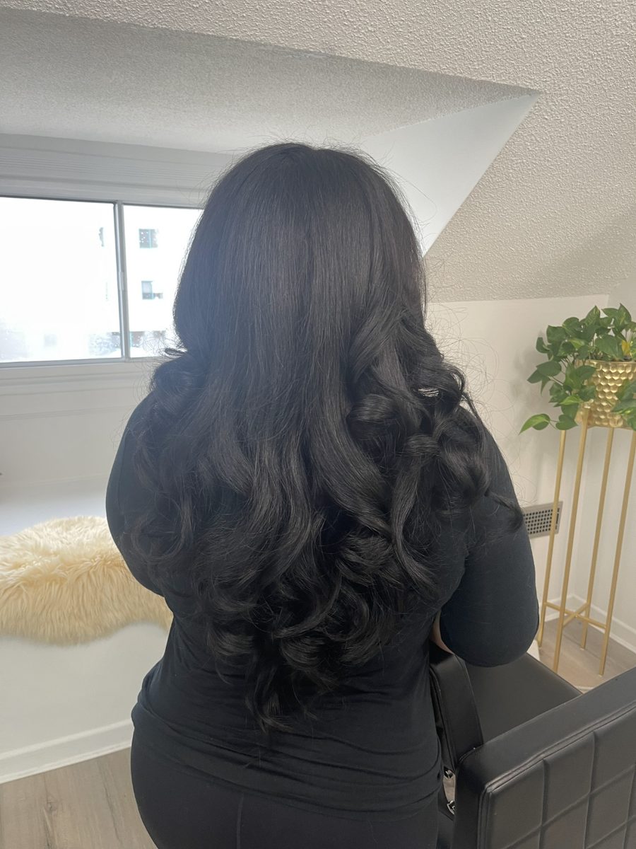Long black hair in glossy blow-dried waves