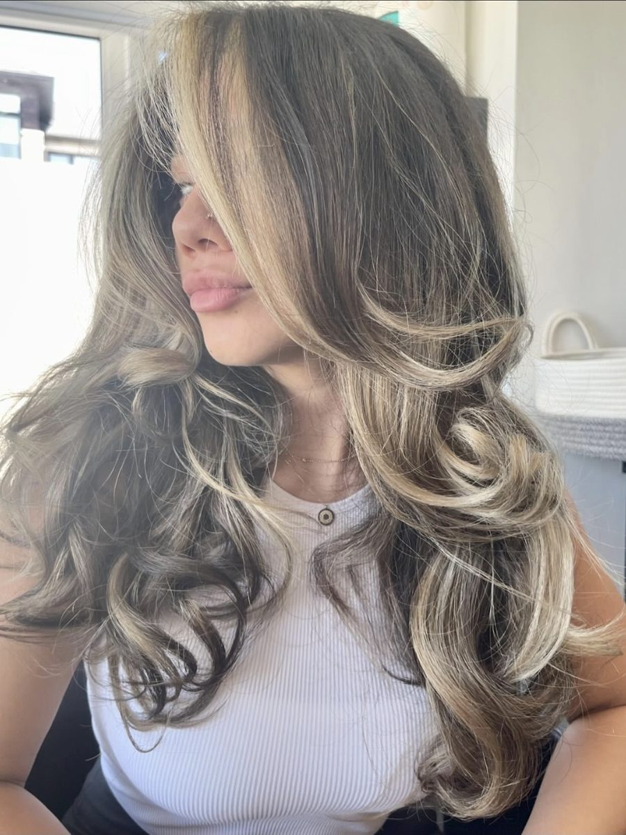 Dimensional blonde balayage with soft waves and face-framing highlights