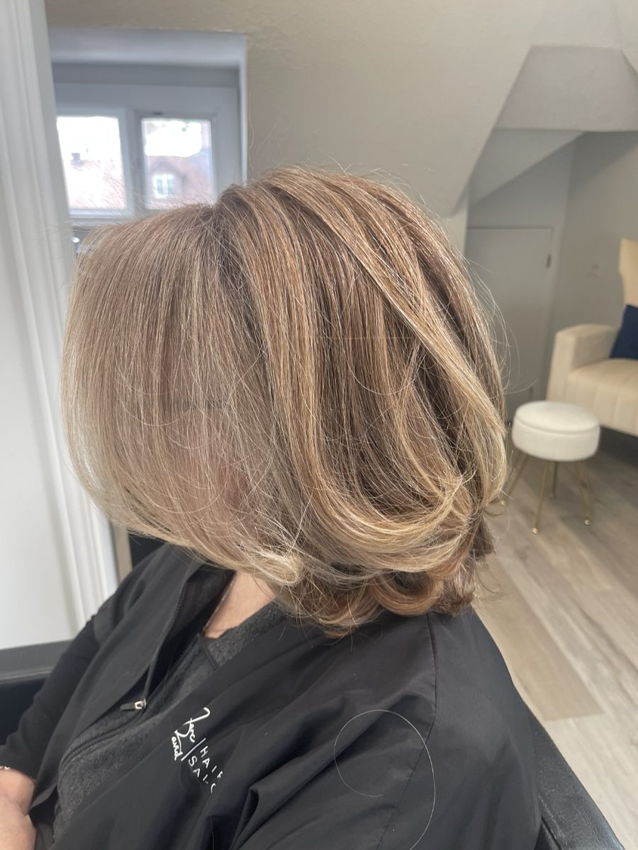 Honey blonde bob with soft layers and a blow-dried finish